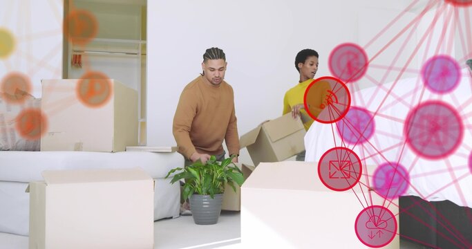 Arranging couple placing plant and carrying boxes in living room, woman in yellow top, red overlay