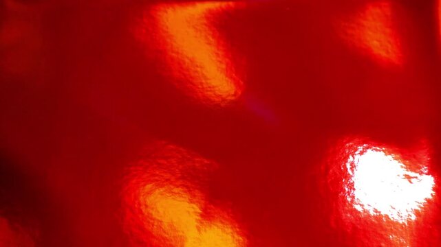 Red lacquer background.Shiny red lacquer texture with light reflections.Red festive background. Christmas and New Year wallpaper.