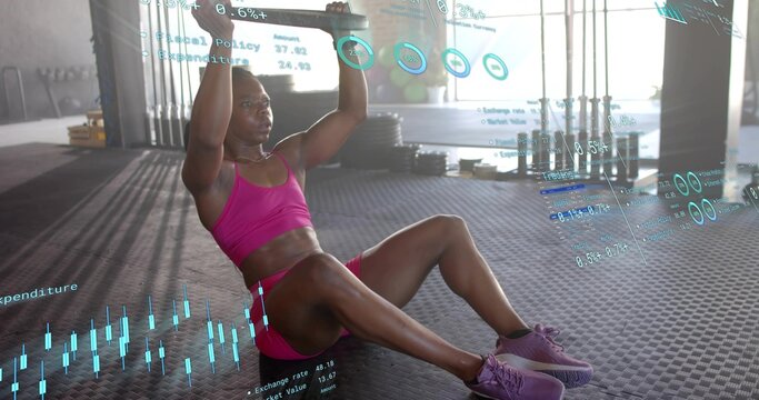 Doing core hold, woman holding bar overhead on rubber floor, wearing magenta sports set with HUD - Powered by Adobe