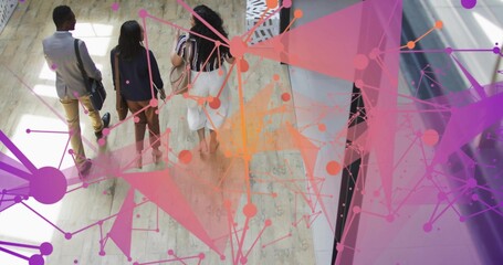 Walking three coworkers in blazers carrying bags across wood floor, showing network overlay