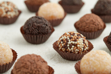 Typical Brazilian sweet brigadeiro. Assorted flavors of candies on a white table
