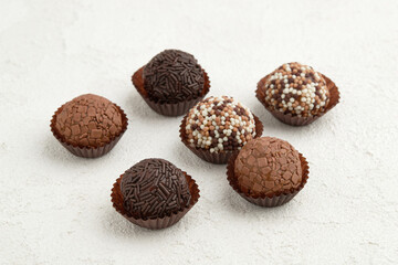 Typical Brazilian sweet brigadeiro. Assorted flavors of candies on a white table