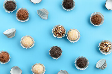 Typical Brazilian sweet brigadeiro. Assorted flavors of candies in a line on a blue background