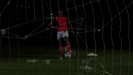 Male soccer player stepping forward, kicking ball through goal net while tech HUD analyzing shot - Powered by Adobe