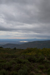 Vertical Mountain View of Reservoir Valley and Cloudy Sky at Dusk © MiguelA