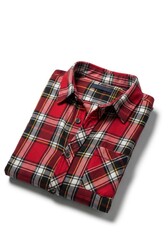 A neatly folded red black and white plaid shirt with yellow accents featuring a collar buttons and a visible chest pocket rests on a bright background