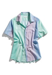 A pastel-colored short-sleeved collared shirt laid flat on a white surface with shadows It features vertical stripes and color blocking in blue green and purple