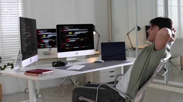 Programmer working on computer at white table in office