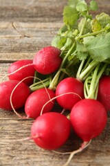 Fresh ripe radishes on wooden table, closeup