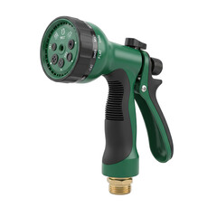 Green garden hose nozzle with multiple spray settings and brass connector isolated on a black background with studio lighting
