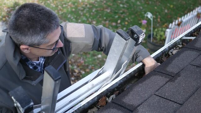 Homeowner or Contractor Cleaning Full Gutters