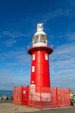 Red lighthouse with white top section at Fremantle Harbour Entrance.