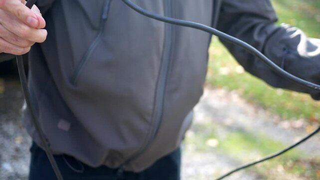 Man Untangling an Extension Cord