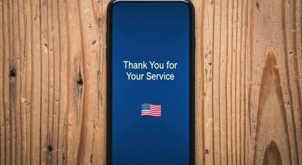 Veterans day mobile tribute with american flag and thank you message on wood background
