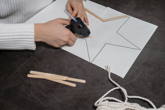 Ice cream sticks Christmas star Sustainable preparation Diy process making handmade decoration. Step by step activity for children. Inclusive and responsible stress relief holiday hobby. Conscious