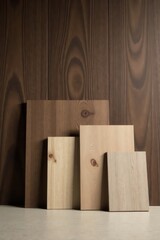 Collection of Wooden Samples Showing Different Shades and Grain Patterns Against a Dark Wood Background