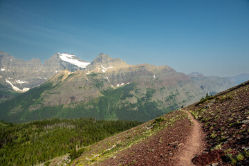 Backpacker Looks Out Over The Spectacular View In Glacier