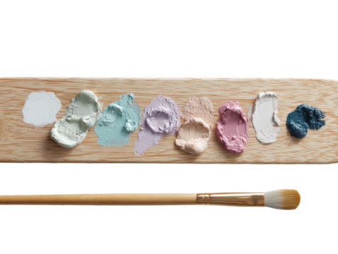 Pastel paint smears on wood, with brush