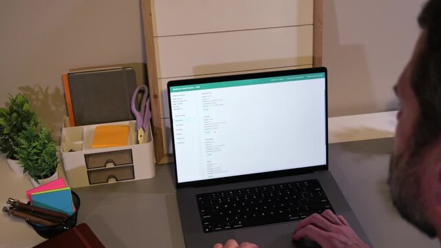 Middle Aged Man Checking His Electronic Medical Records - EMR at Home Concept