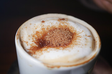 Delicious coffee topped with creamy foam and brown sugar