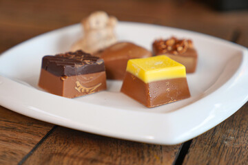 Delicious assorted chocolates on a white plate
