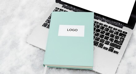 Pastel Notebook on Laptop - A Modern Workspace Aesthetic.