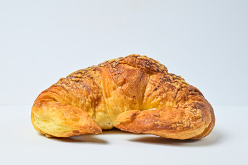 Side view of cheese croissant isolated on white background. Clipping path. Fresh, brown. close up.