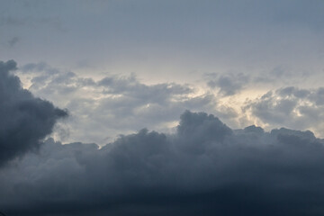 The dark sky with heavy clouds converging and a violent storm before the rain.Bad or moody weather sky and environment. carbon dioxide emissions, greenhouse effect, global warming, climate change.