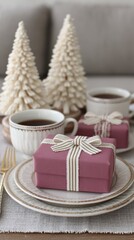 Holiday table decorated with wrapped presents, white decorative trees, and steaming mugs of coffee for a cozy winter celebration