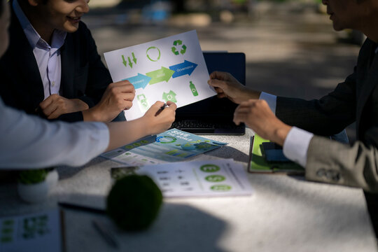 Businesspeople discussing esg sustainability with recycling symbols