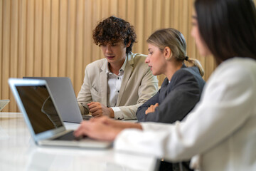 Diverse tech team meeting on software project, mentor guiding coworker on laptop, teamwork development using collaboration tools, modern technology, app design, dev training and enterprise SaaS team