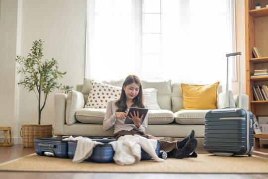 Portrait of woman use technology of tablet computer for hotel and resort booking online summer holiday travel system planning searching information weekend vacation trip.reservation online travel