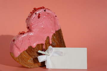Empty paper note template sample mock up blank for wishes greeting holiday card Heartshaped pastry croissant treat topped with colorful frosting galore. Food experimentation viral dessert creative