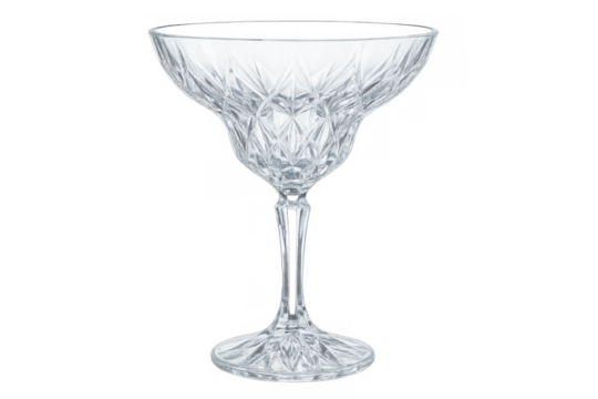 Elegant crystal coupe glass with elaborate cut pattern, ready for cocktails or champagne on a transparent background