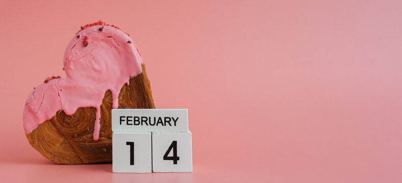 Valentine's Day 14 February wooden calendar cubes wishes greeting holiday card Heartshaped pastry croissant treat topped with colorful frosting galore. Food experimentation viral dessert creative