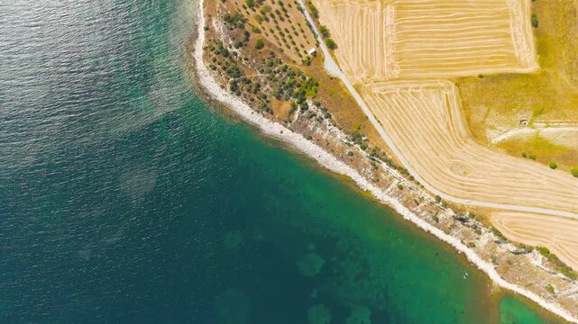 Seddulbahir, Eceabat, Turkey. Aerial view of historic Mehmetcik Feneri lighthouse at Cape Helles on Gallipoli Peninsula with Dardanelles Strait and Aegean Sea. Clear sunny day. Aerial View
