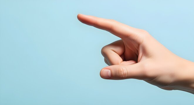 A close-up of a human hand gesturing with an extended index finger pointing left on a clean blue background, representing choice, direction, or interaction