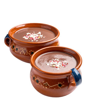 Creamy and comforting mexican champurrado in a cup, a spiced chocolate atole for cold days, isolated on a white background