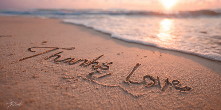 Thanks Love Written Elegantly in Sand with Thin Lines on a Clean Surface – perfect for greeting cards