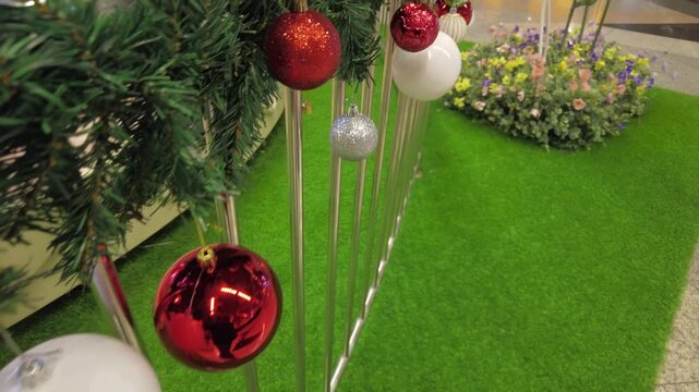 A reflection of a man can be seen on the Christmas ornament, a creepy stalker concept.