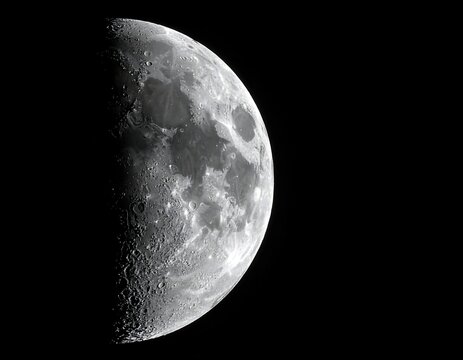 Close-up of half-lit lunar surface against a stark black void