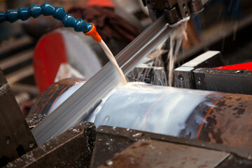Large Saw Cutting Large Piece of Metal Bar