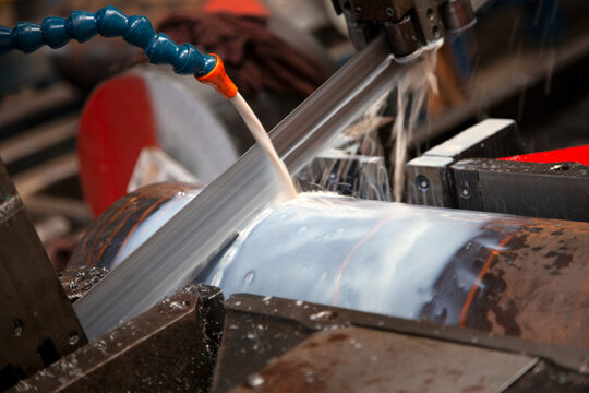 Large Saw Cutting Large Piece of Metal Bar
