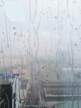 The texture of the condensation on the glass in droplets of water. High humidity on the windows. Natural photo in the cold season