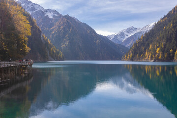 Long Lake in autumn in Jiuzhaigou National Park is a famous lake with crystal clear water and beautiful mountain backdrop. Sichuan, China