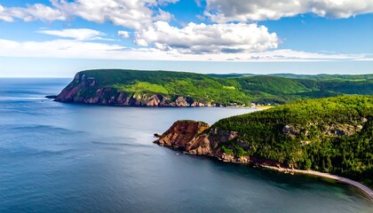 Aerial view of coastal cliffs, ocean, and lush green hills under a sky