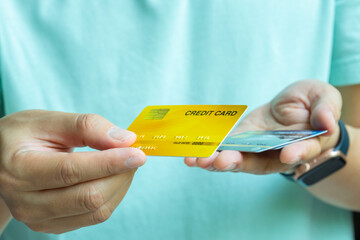 Woman holding credit cards and he is choosing a credit card to pay and spend Payment for goods via credit card. Finance and banking concept