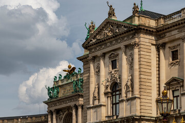 Historic Baroque Palace with Ornate Sculptures and Corinthian Columns under Cloudy Sky