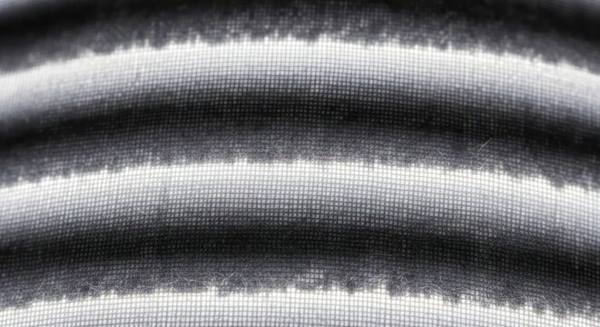 Abstract textile design with varying shades of grayscale and interlaced fine weaves