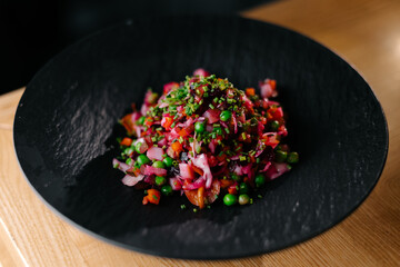 Healthy beetroot and vegetable salad with peas and onions, vegan colorful dish
